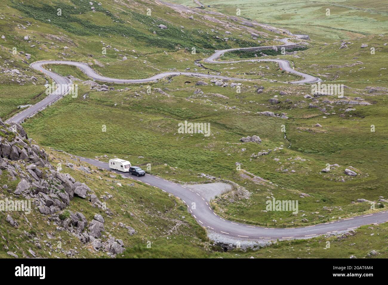 Healy Pass, Cork, Ireland. 31st July, 2021. Holidaymakers climb the steep incline of the serpentine road with their caravan as they head over the Healy Pass in West Cork, Ireland. - Picture; Credit: David Creedon/Alamy Live News Stock Photo