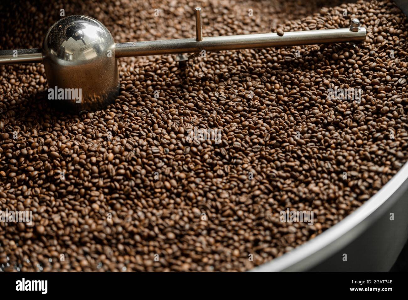 Coffee processing. Roastery, roasting machine and fresh beans Stock