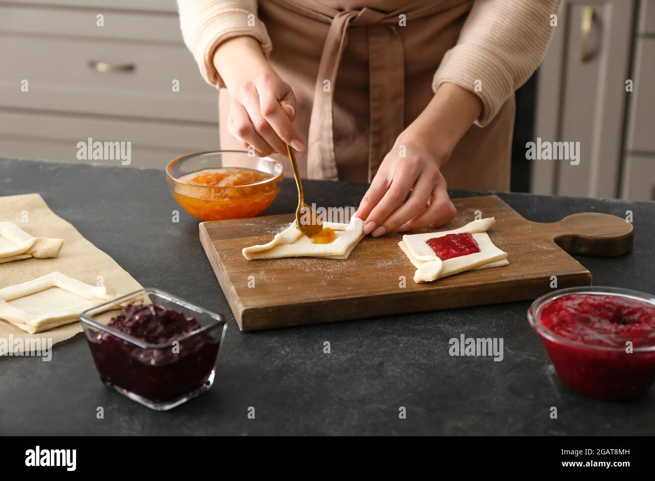 Female hands adding cherry filling hi-res stock photography and images ...