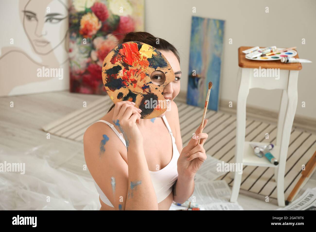 Young female artist painting in workshop Stock Photo - Alamy