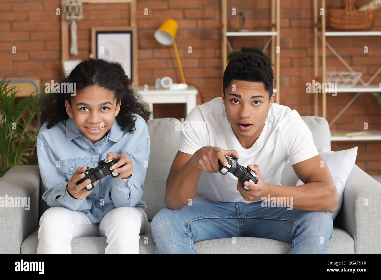 African American Brother And Sister Playing Video Game At Home Stock 