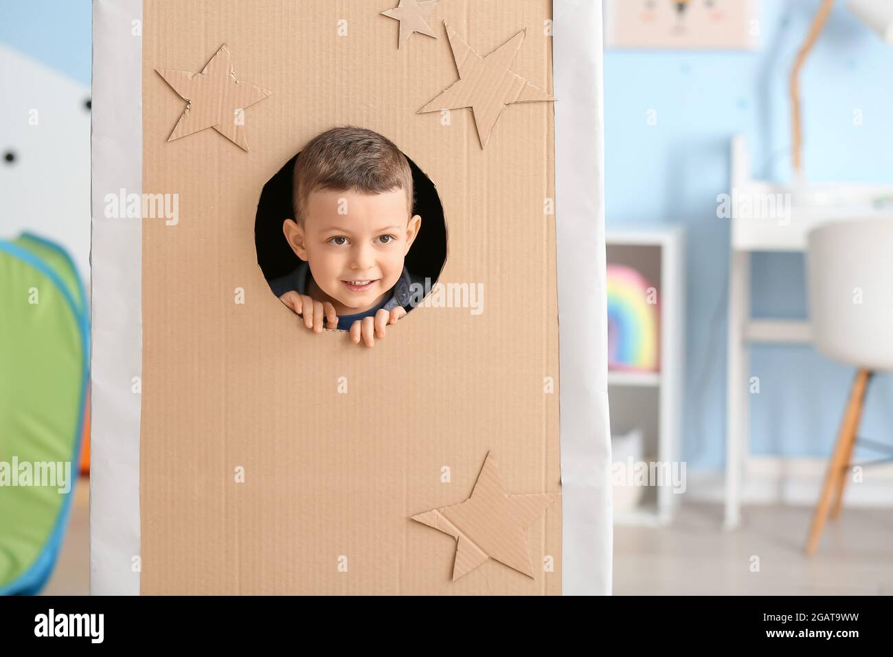 Cute little boy playing with cardboard rocket at home Stock Photo - Alamy