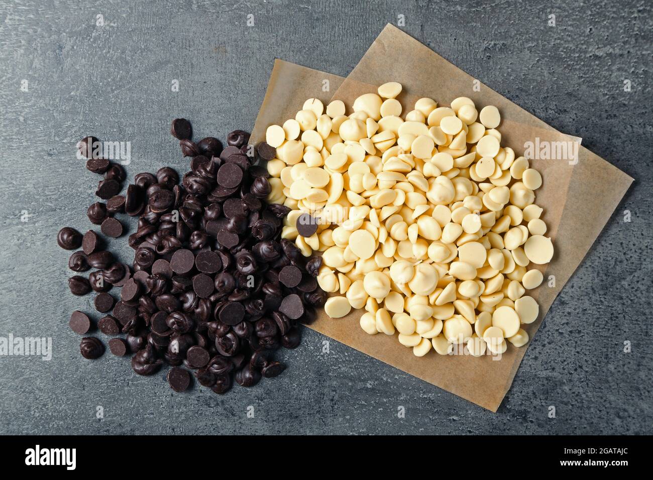 Dark and white chocolate morsels on gray background Stock Photo Alamy