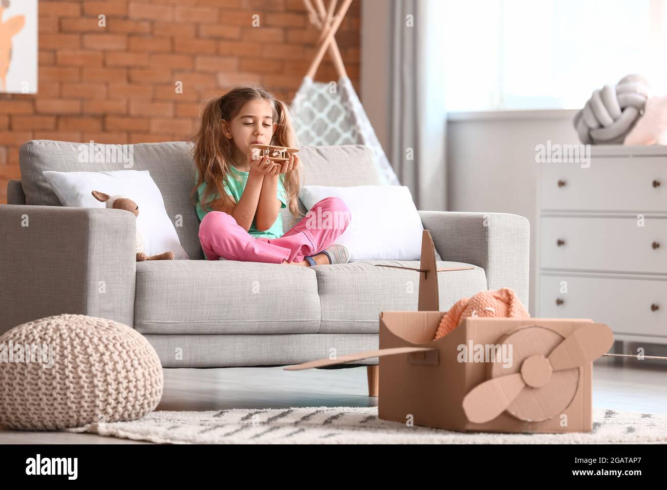 Little girl playing with toy at home Stock Photo - Alamy
