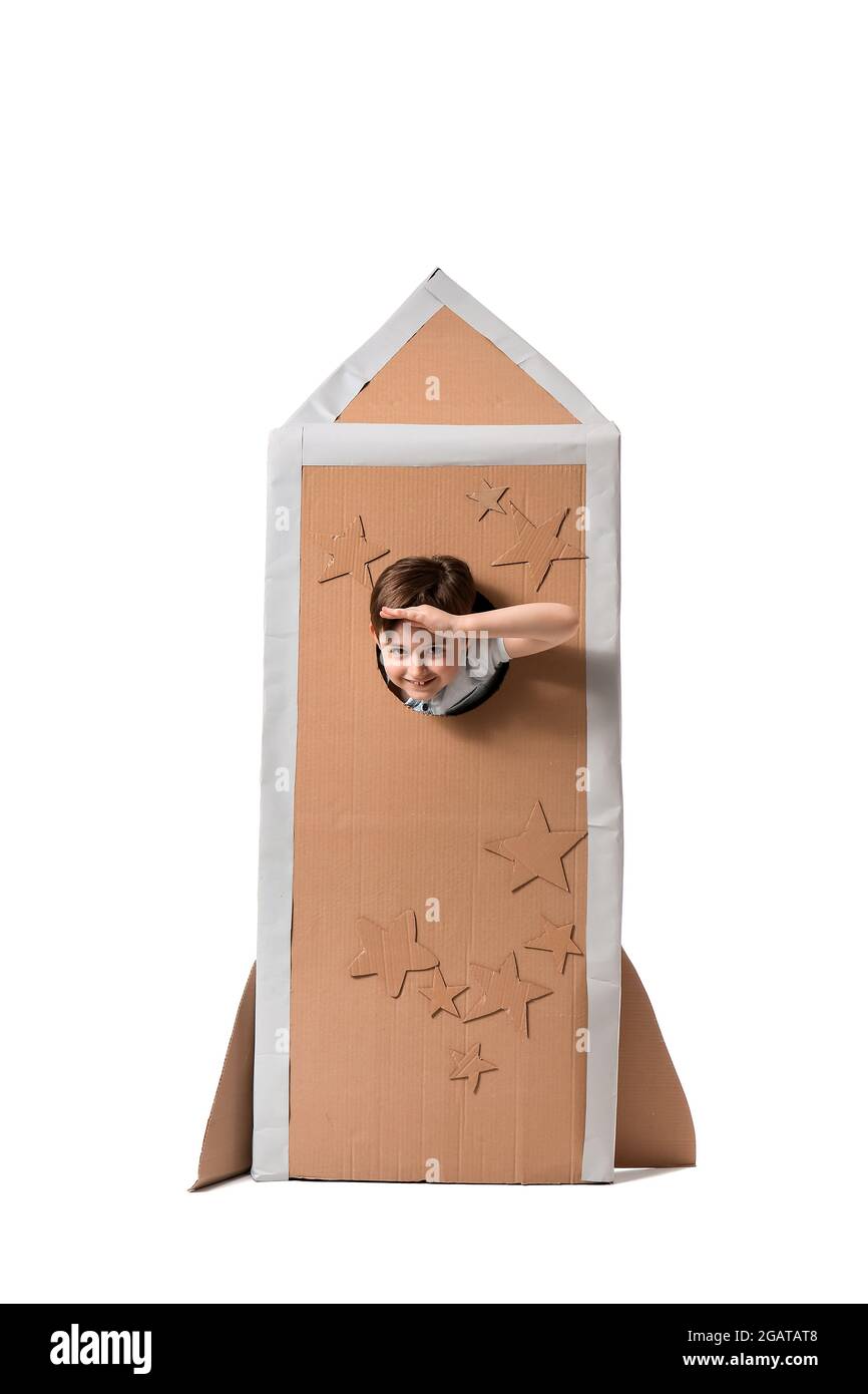 Cute little boy in cardboard rocket on white background Stock Photo - Alamy