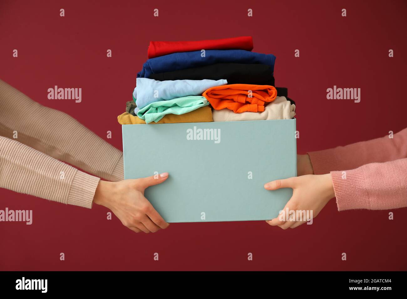 Women and wardrobe box with clothes on color background Stock Photo Alamy