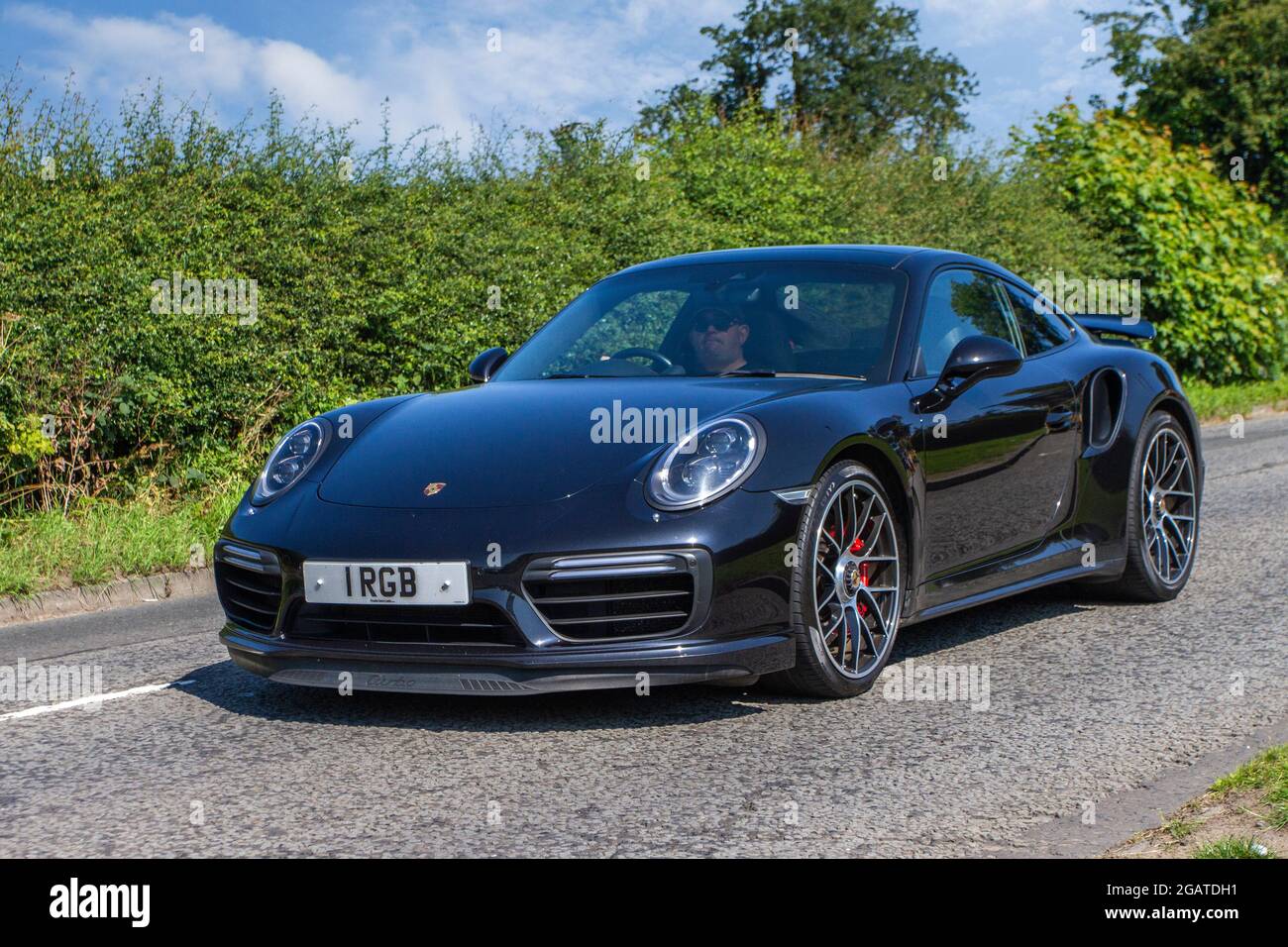 2018 black Porsche 911 Turbo S Exclusive Series 2 speed automatic coupe en-route to Capesthorne Hall classic July car show, Cheshire, UK Stock Photo