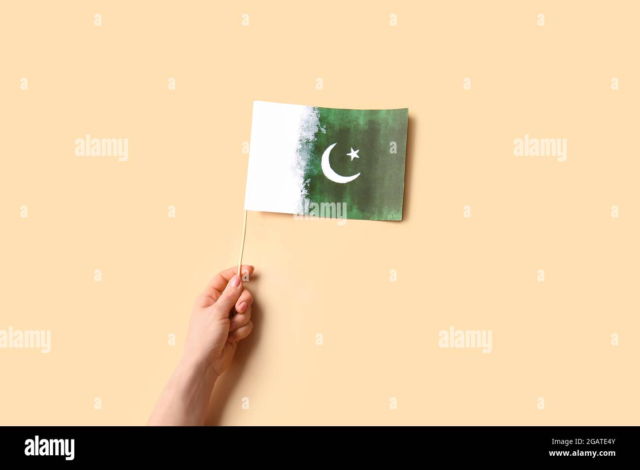 Female hand with Pakistan flag on color background Stock Photo - Alamy
