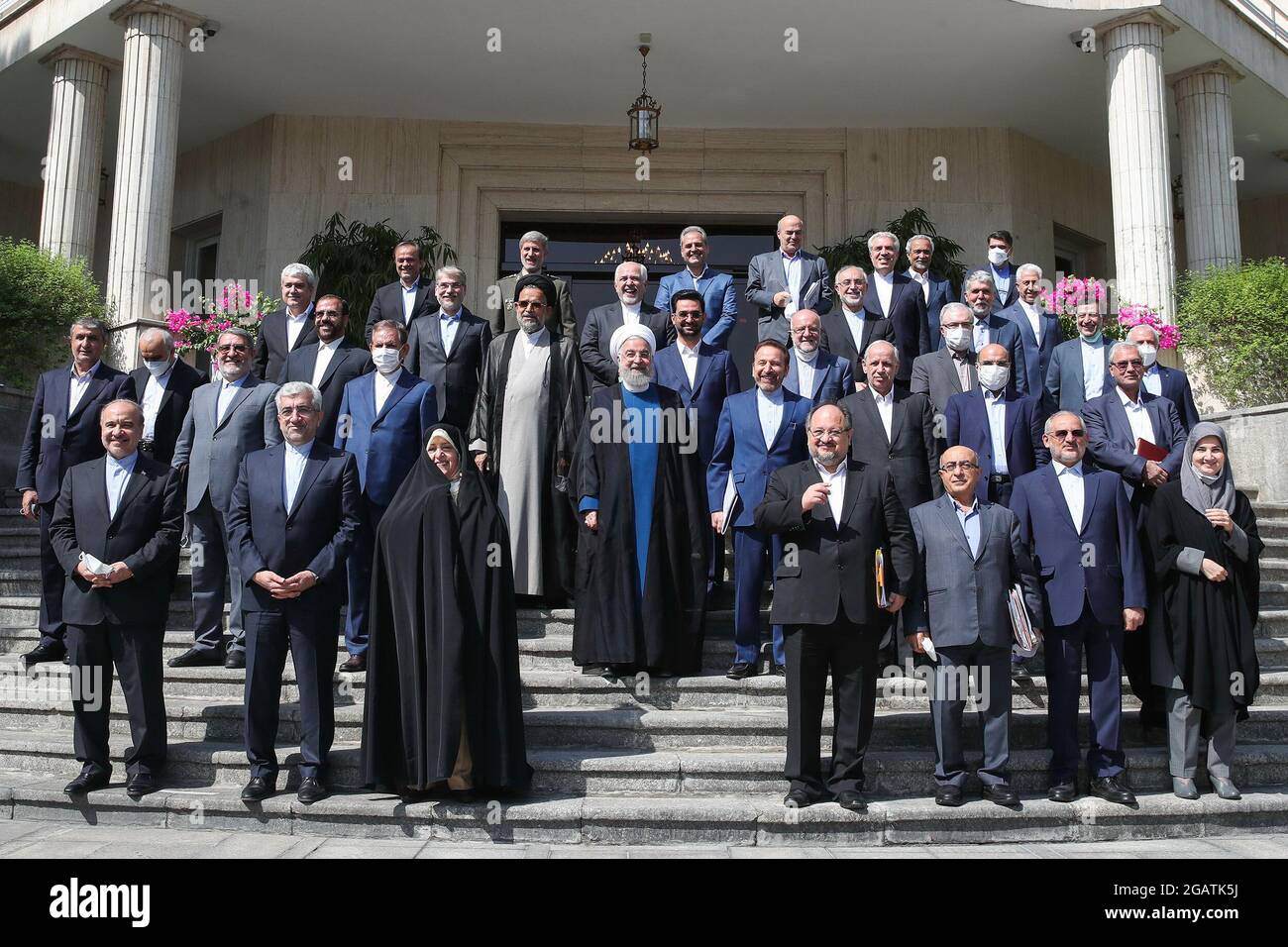 Tehran, Tehran, Iran. 1st Aug, 2021. In this photo released by the official website of the office of the Iranian Presidency, outgoing President HASSAN ROUHANI(C) poses for a family photo after the last meeting of his cabinet in Tehran, Iran, Sunday, Aug. 1, 2021. Rouhani on Sunday acknowledged his nation at times ''did not tell part of the truth'' to its people during his eight-year tenure, as he prepares to leave the office with his signature nuclear deal with world powers in tatters and tensions high with the West. Iran's ultraconservative Ebrahim Raisi will be inaugurated on August 3 as th Stock Photo