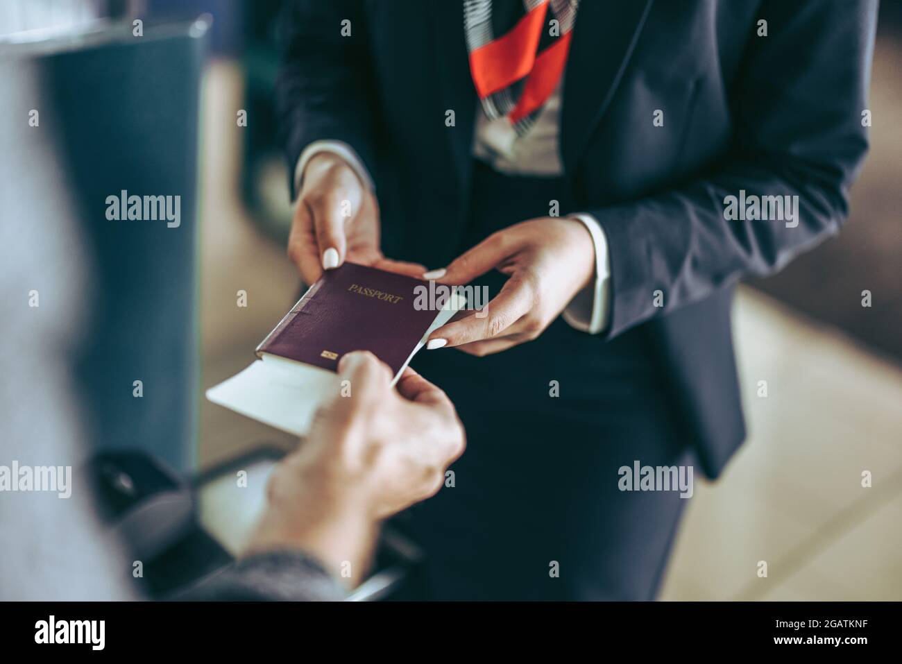 Closeup of flight attendant taking passport of tourist at airport check