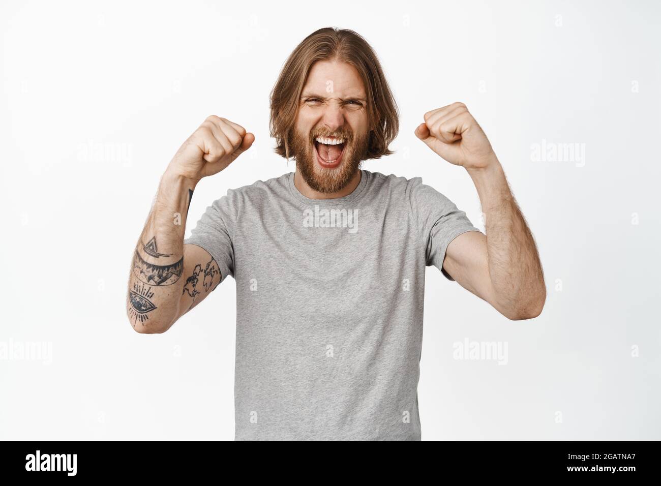 Image of handsome blond man yelling and chanting, winning, become ...