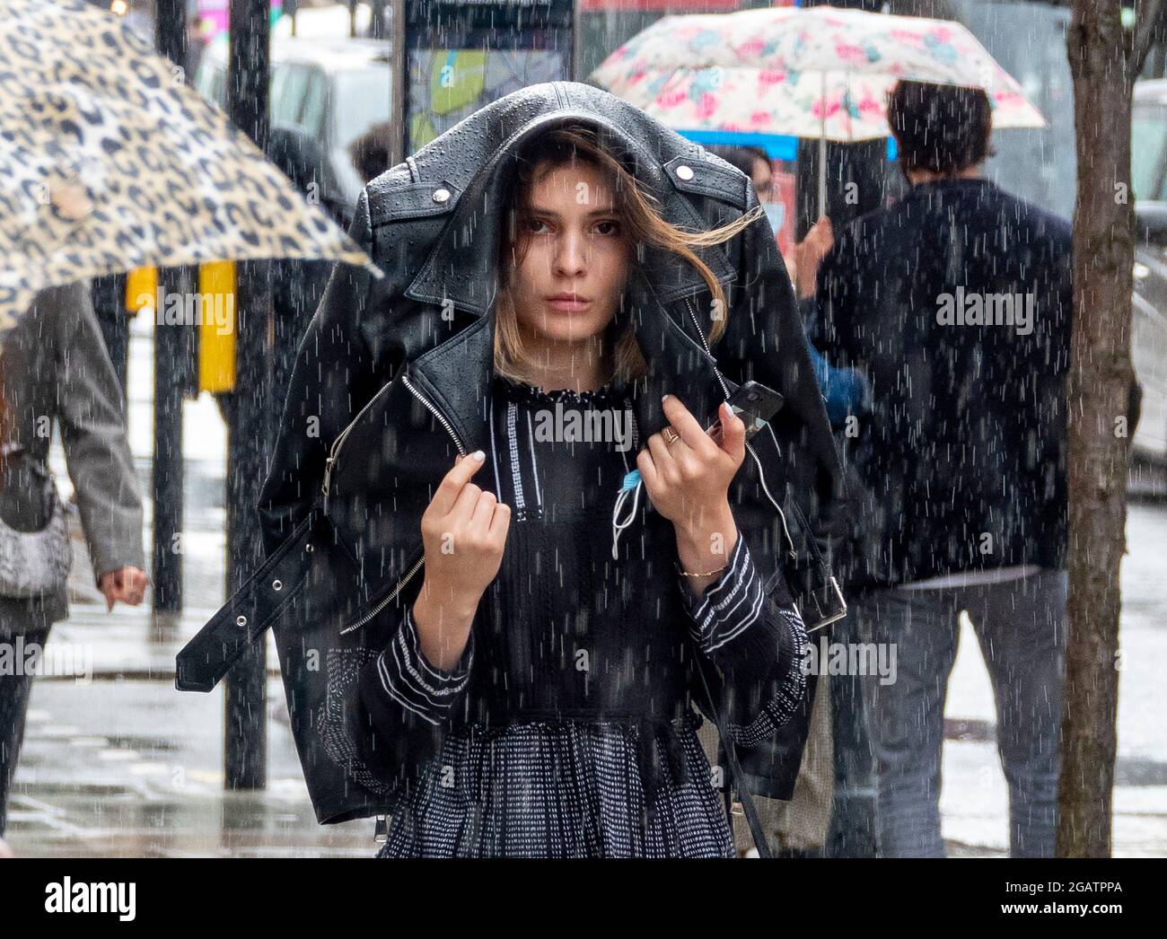 Pic shows: Wet weather battered shoppers in Oxford Street on Saturday afternoon as the rainy July continued to the very last day of the month  31.7.21 Stock Photo