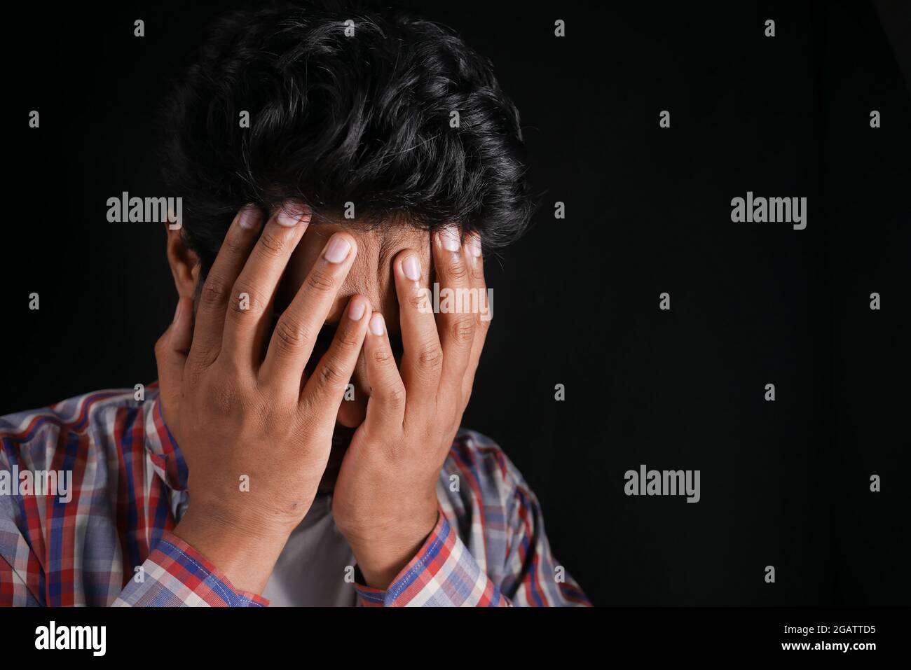 Close up of sad man covering face with hand Stock Photo - Alamy