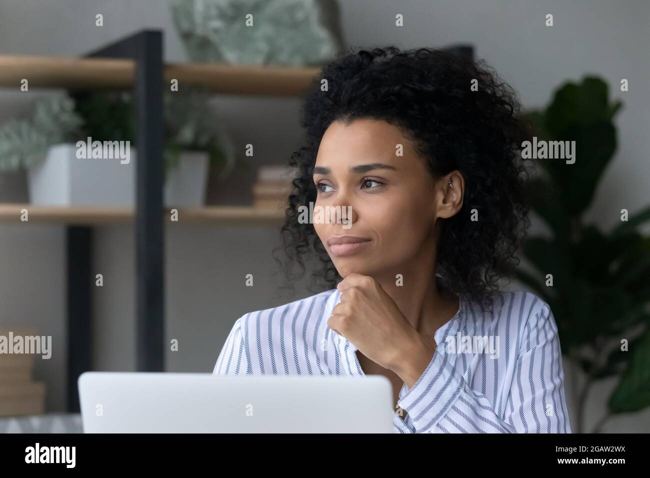 Pensive African American woman work on computer dreaming Stock Photo ...