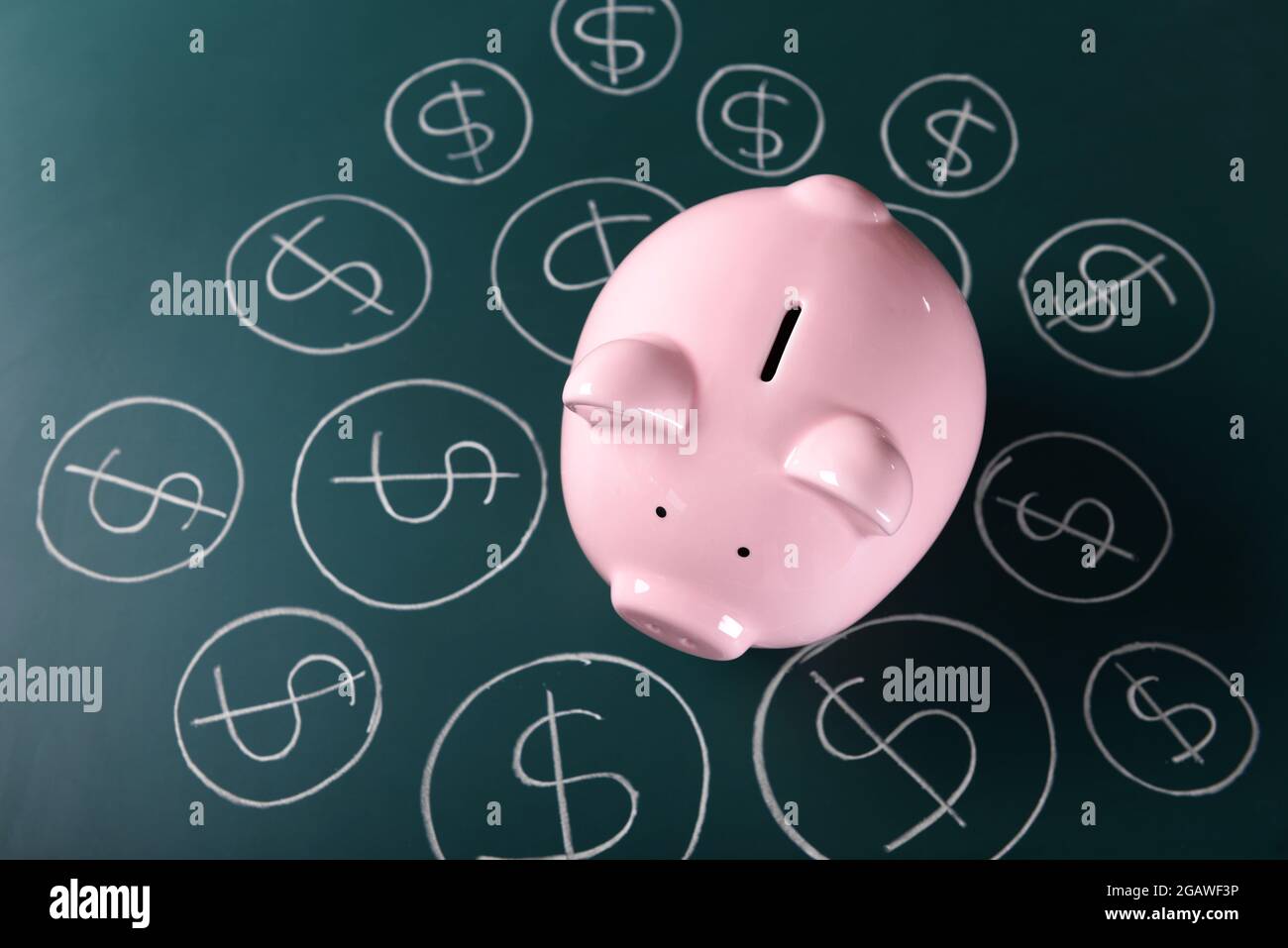 Piggy bank on a chalkboard with Dollar currency symbols Stock Photo - Alamy