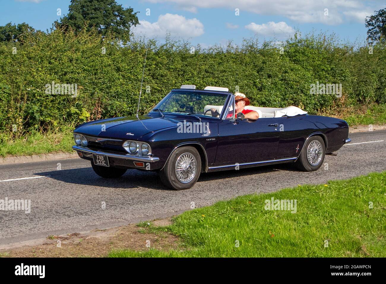 A American 1965 60s Chevrolet Corvair blue cabriolet classic vintage car arriving at the Capesthorne Hall classic car show. Stock Photo