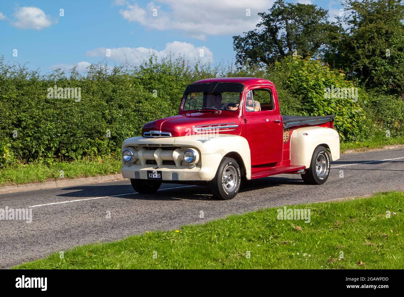 1951 50s 1950s red white American Ford F1 pickup 6400cc muscle car classic vintage car arriving at the Capesthorne Hall classic car show. Stock Photo