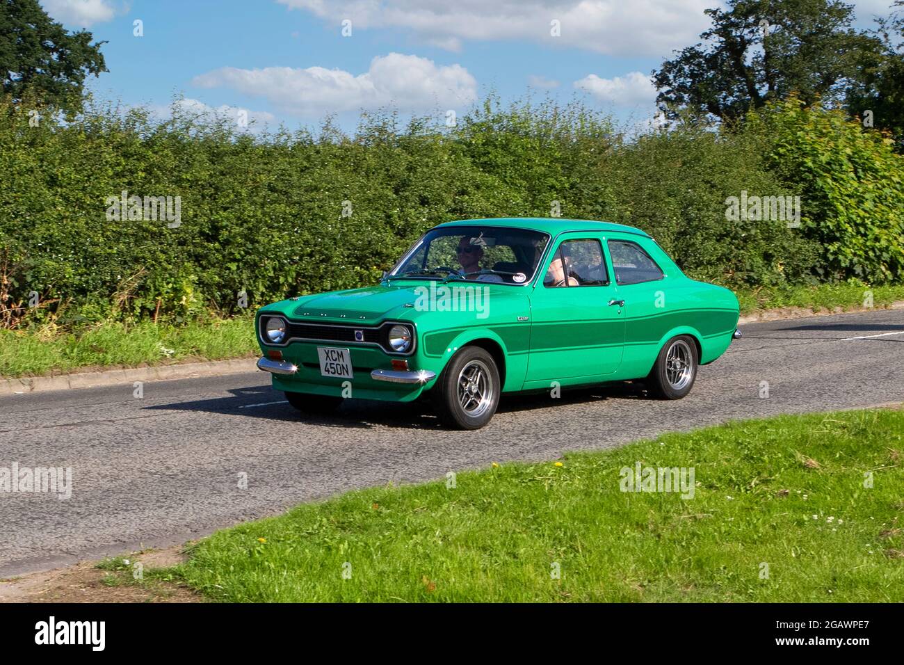1974s, 70s, 1970s green Ford Escort classic vintage car arriving at the Capesthorne Hall classic car show. Stock Photo