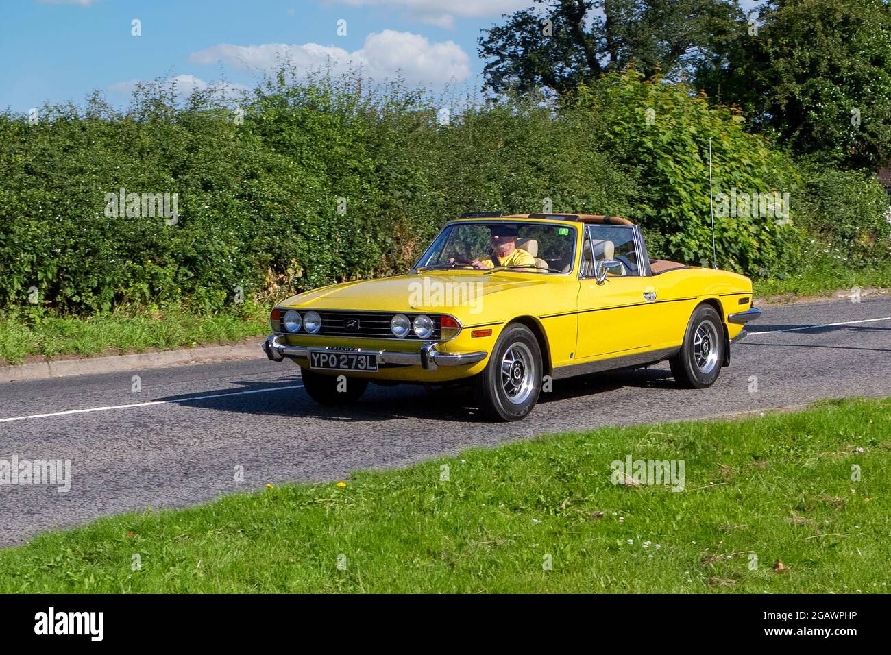 1972, 70s, 1970s, Yellow Triumph Stag cabriolet; classic vintage car arriving at the Capesthorne Hall classic car show. Stock Photo