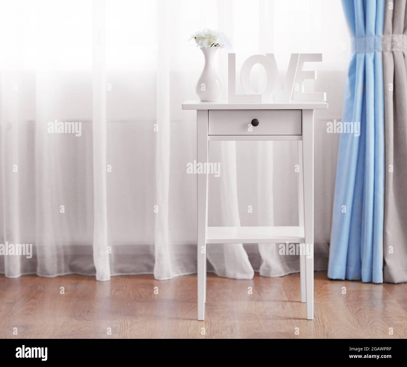 Little table in the room in front of window with curtains Stock Photo ...