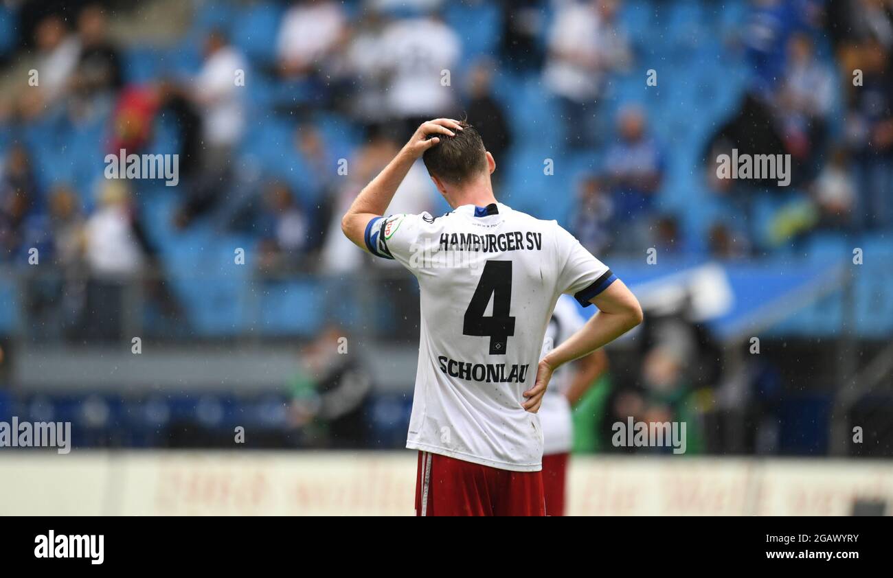 Hamburg, Germany. 01st Aug, 2021. Football: 2nd Bundesliga, Matchday 2: Hamburger SV - Dynamo Dresden at Volksparkstadion. Hamburg's Sebastian Schonlau stands on the pitch after the final whistle and grabs his head. Credit: Daniel Reinhardt/dpa - IMPORTANT NOTE: In accordance with the regulations of the DFL Deutsche Fußball Liga and/or the DFB Deutscher Fußball-Bund, it is prohibited to use or have used photographs taken in the stadium and/or of the match in the form of sequence pictures and/or video-like photo series./dpa/Alamy Live News Stock Photo