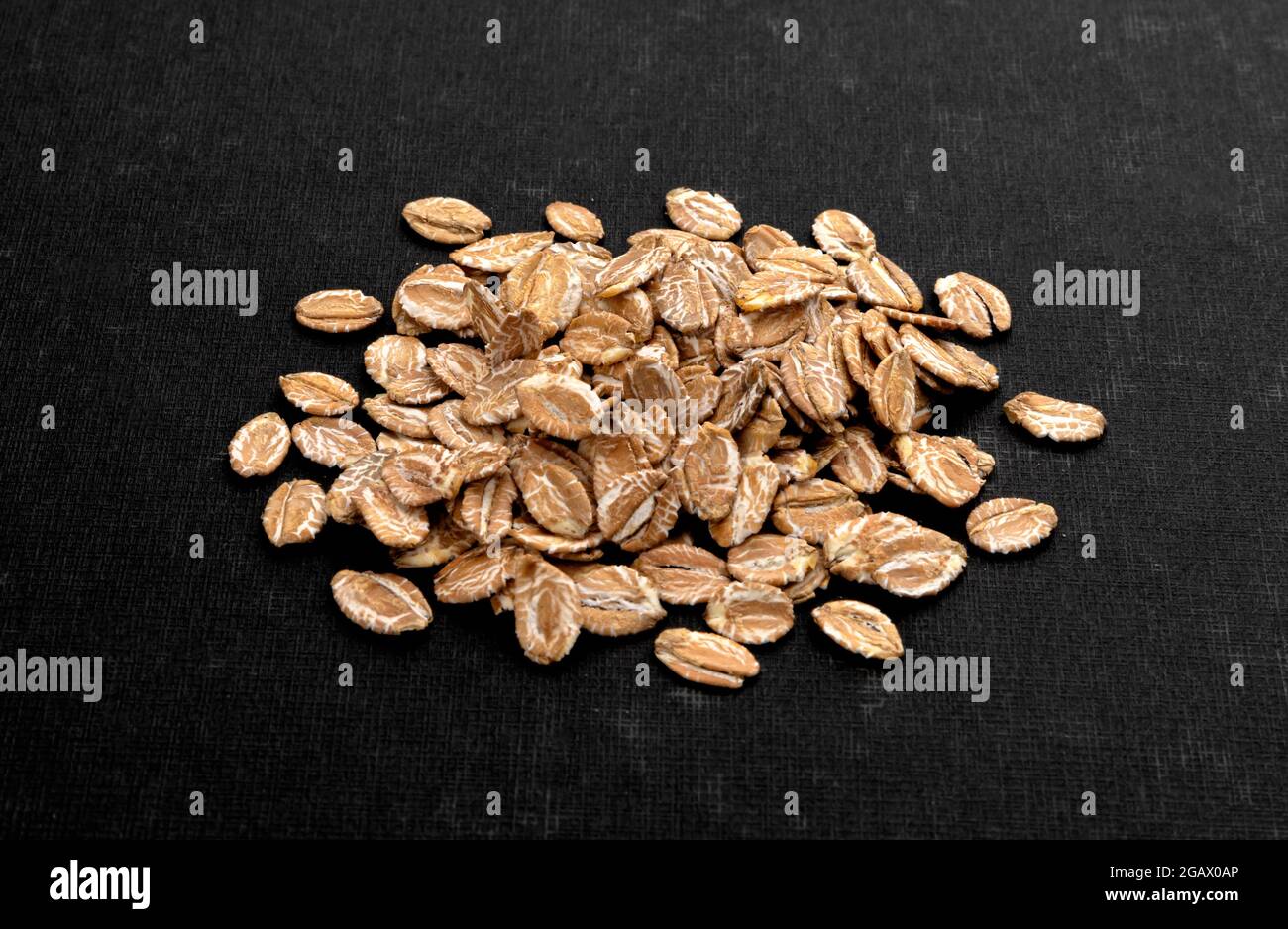 Top view of oat flakes on black background Stock Photo