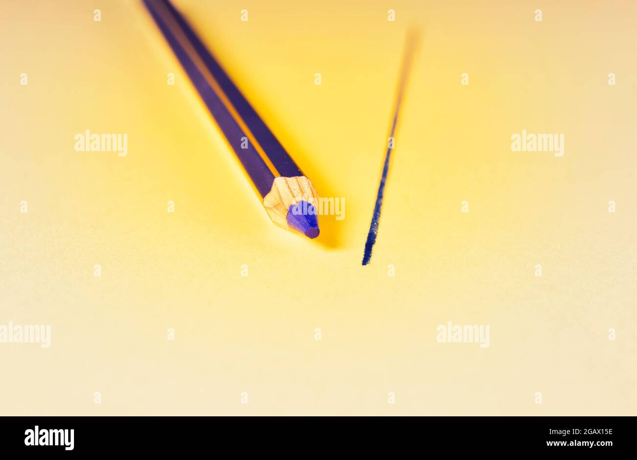 One blue wooden pencil and blue line on yellow background Stock Photo