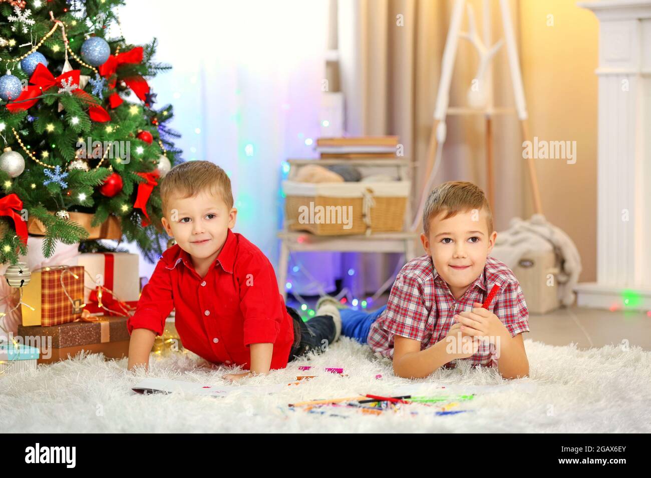 Two cute small brothers drawing on Christmas tree background Stock ...