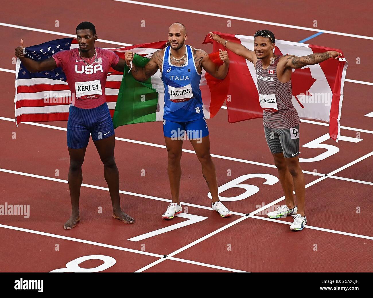 Tokyo Japan 1st Aug 2021 Lamont Marcell Jacobs C Of Italy Fred Kerley L Of The United States And Andre De Grasse Of Canada React After The Men S 100m Final At The