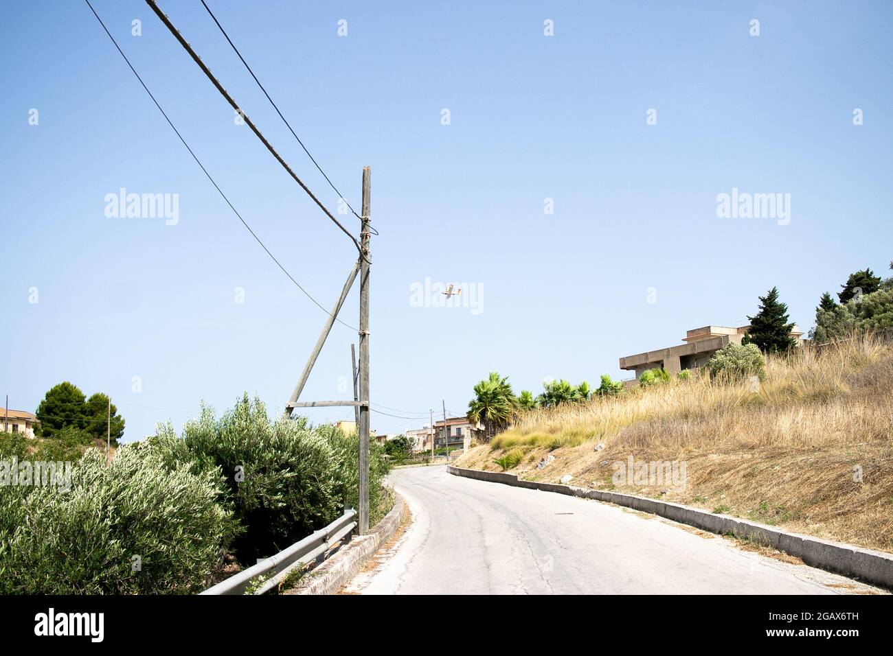 A walk in a small village near Trapani, Sicily Hot streets, torrid summer weather.  Heat and sultriness accompany the solitude of the suburbs. Stock Photo