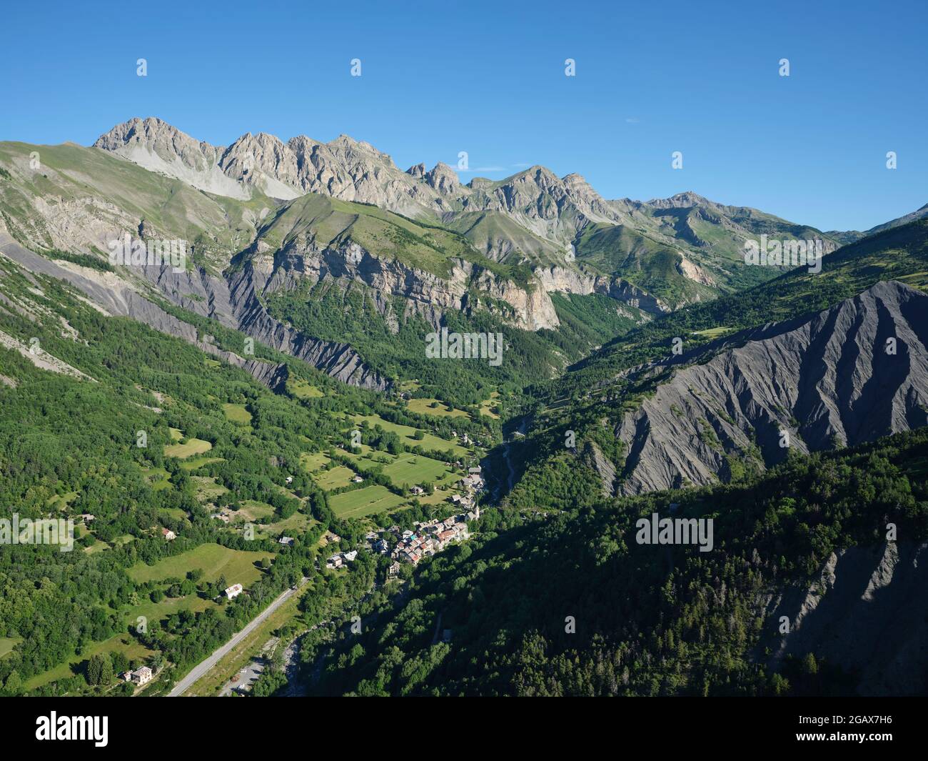 AERIAL VIEW. Wide angle view of the Upper Var Valley with the village of Entraunes; the gateway to the Mercantour Park. Alpes-Maritimes, France. Stock Photo