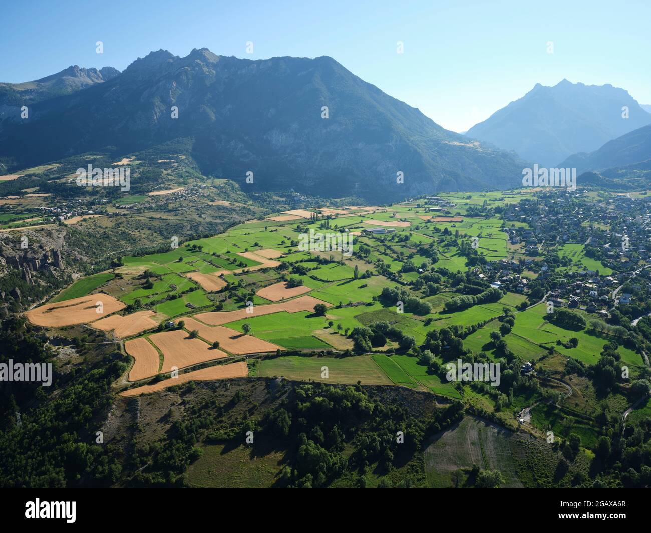 AERIAL VIEW. Farmlands on the outskirts of Guillestre. Durance Valley, Hautes-Alpes, France. Stock Photo