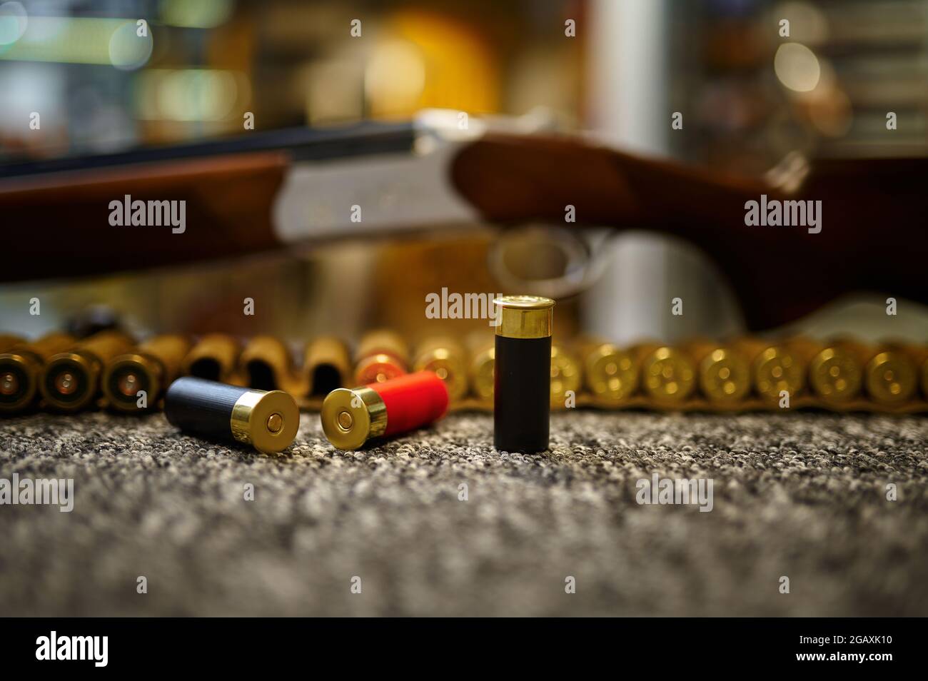 Hunting rifle, bandolier and cartridges, gun store Stock Photo Alamy