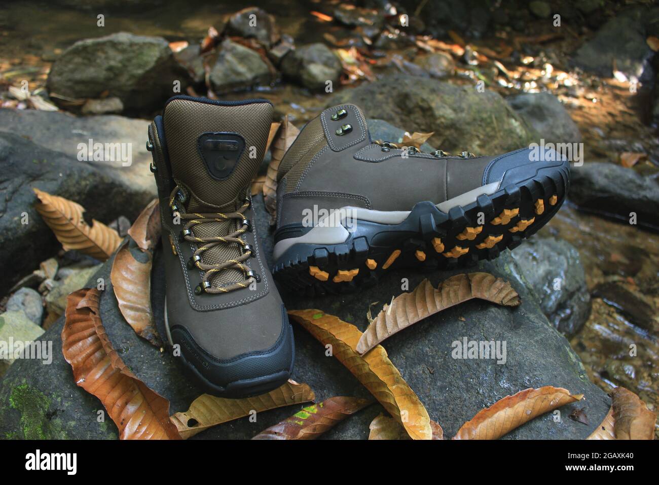 boots with a masculine design for outdoor adventure activities, with jagged soles suitable for tropical and snowy terrain. Stock Photo