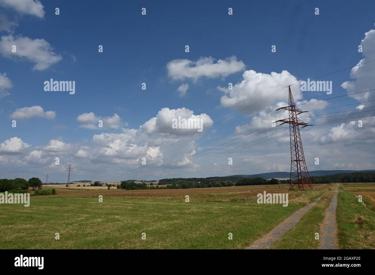Summer landscape in Schaumburg with stubble field and power transmission line Stock Photo