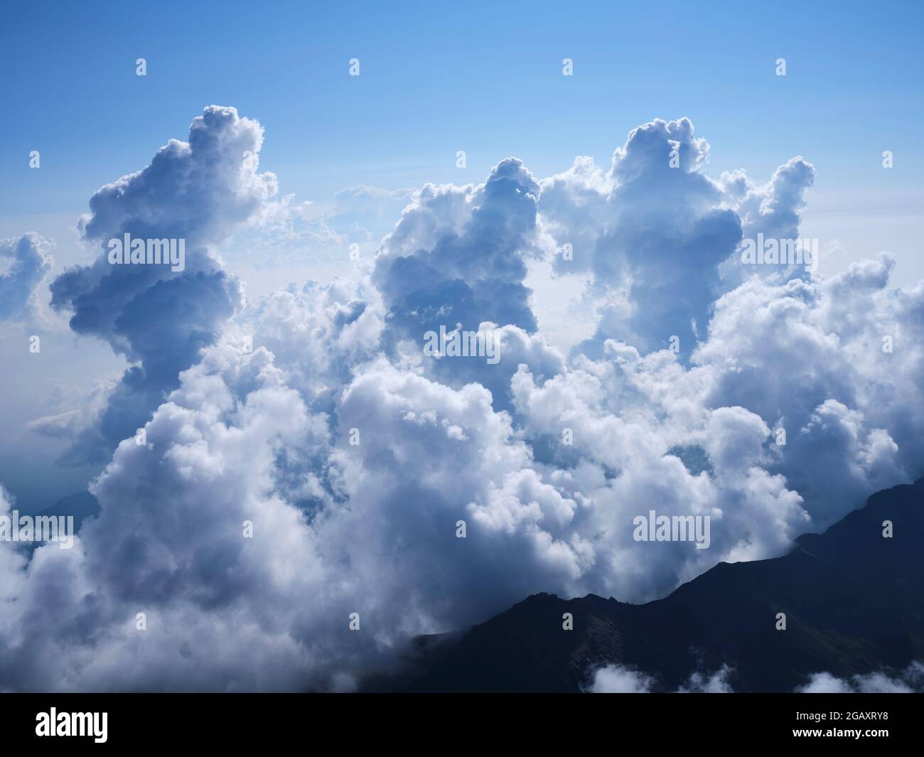 AERIAL VIEW. Towering cumulus clouds reaching about 4000 meters above the Po Plain east of Monte Viso. Province of Cuneo, Piedmont, Italy. Stock Photo