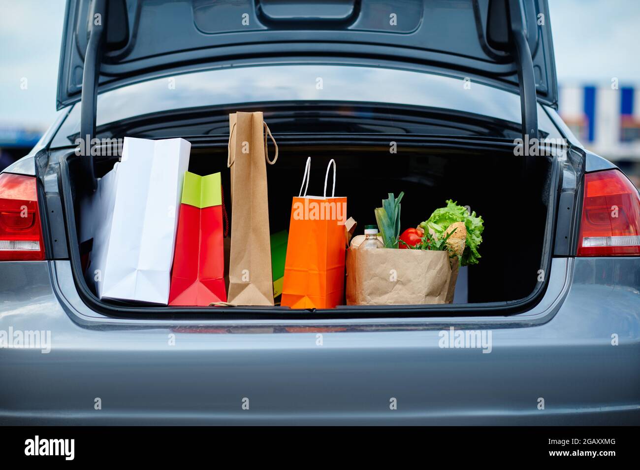 Car with cardboard bags in opened trunk Stock Photo Alamy