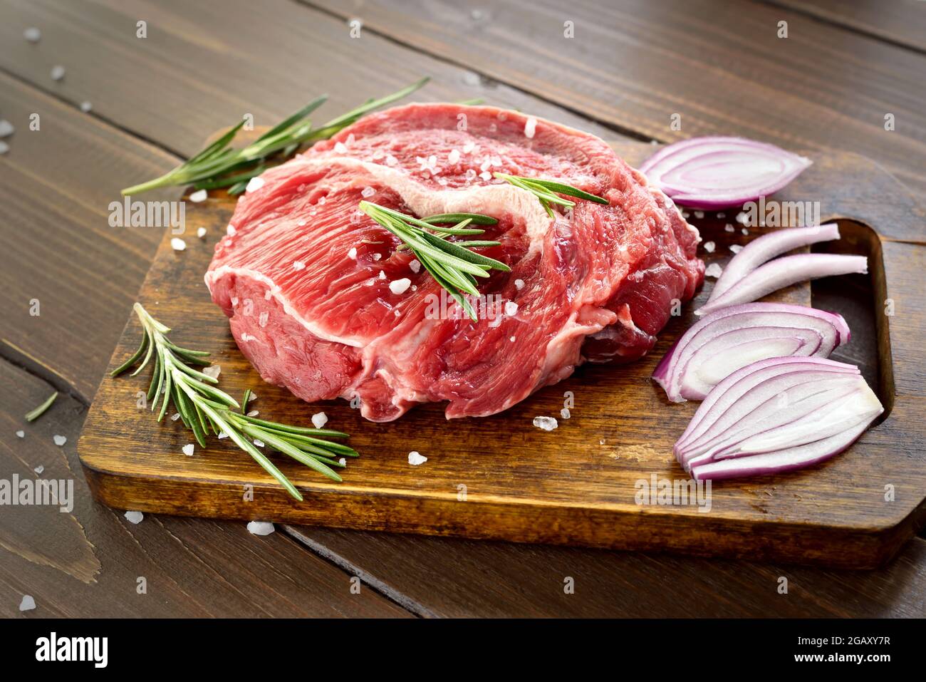 Raw beef steak on cutting board, close up view Stock Photo