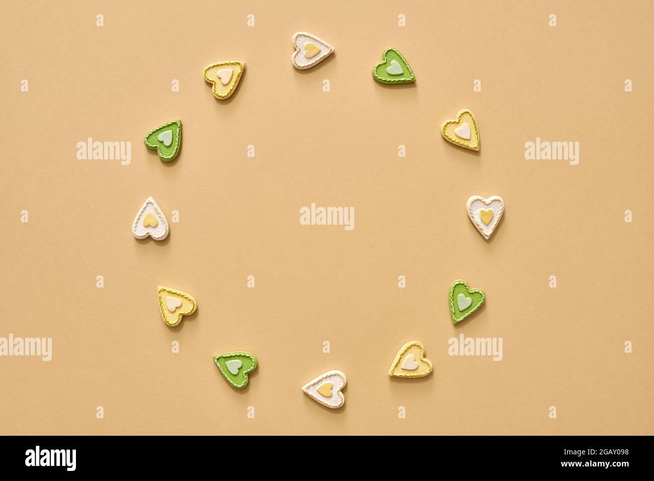 Pastel background with green and yellow hearts, with circular copy space Stock Photo
