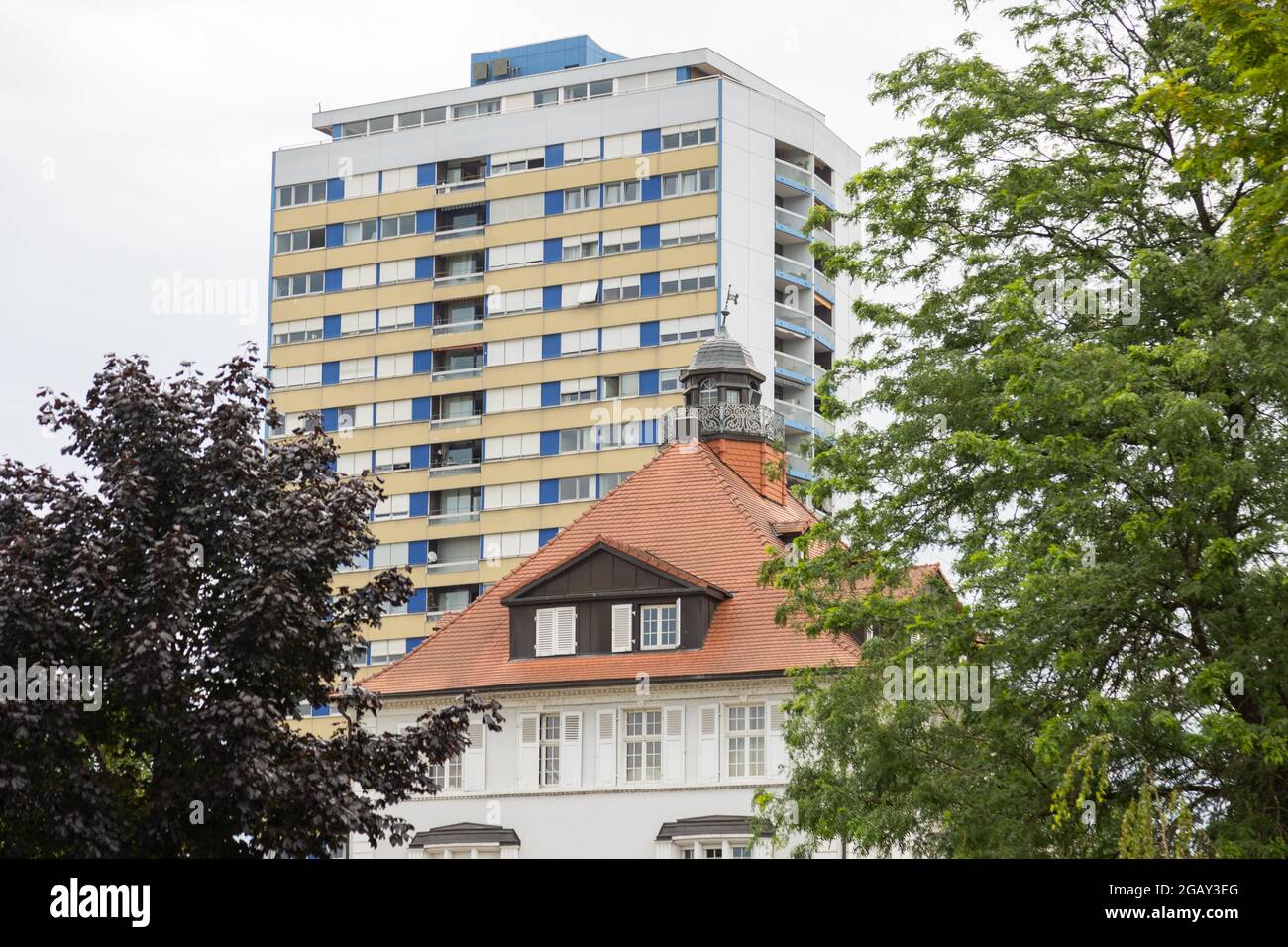 The Villa Schmidt townhouse in front of a highrise residential