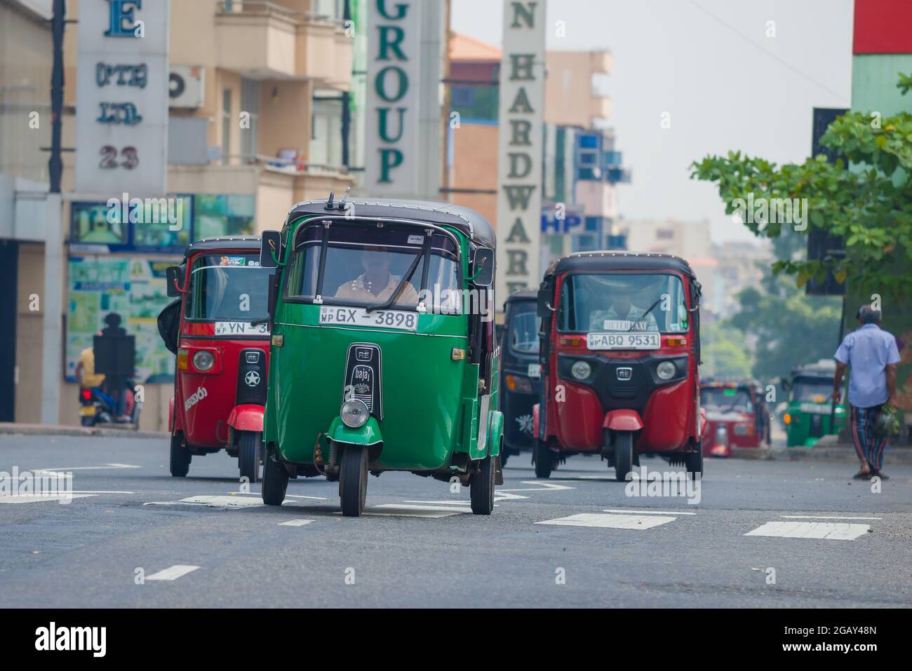COLOMBO, SRI LANKA - FEBRUARY 23, 2020: Several tuk-tuks in traffic on a city street Stock Photo