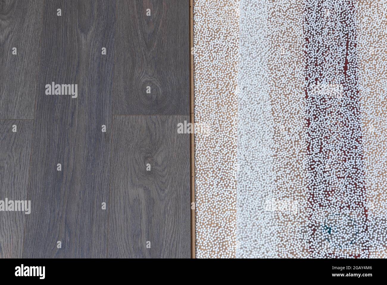 Vertical boundary of laminate laid on substrate. Apartment repair Stock Photo