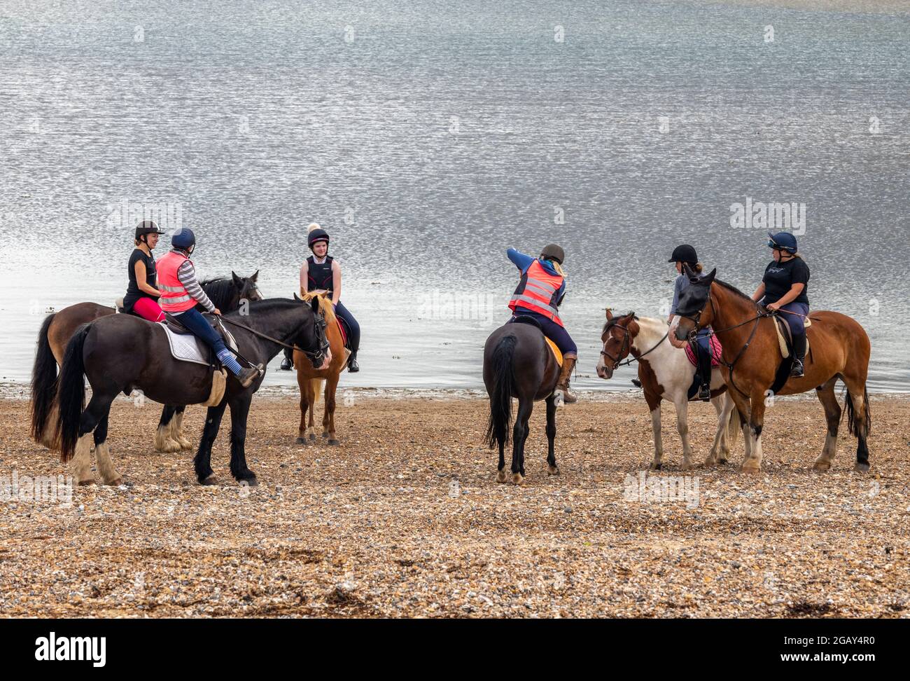 horse riders on the beach at bembridge on the isle of wight, riding