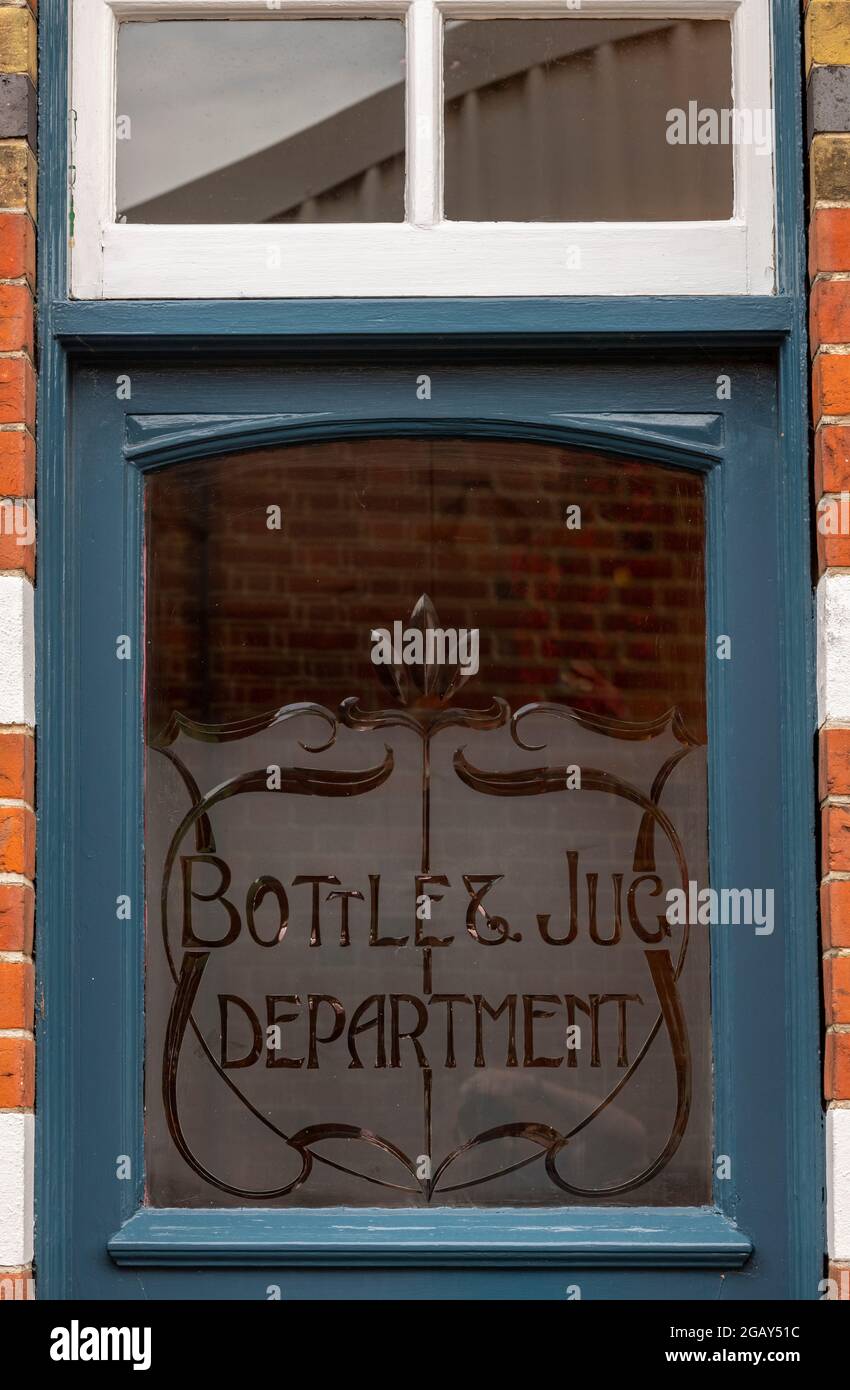 old brewery sign etched in glass on a public house door Stock Photo