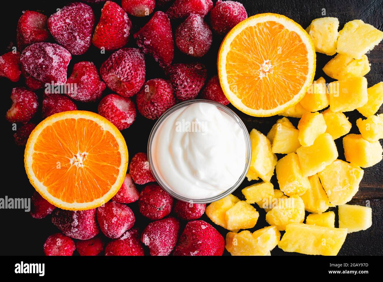 Strawberry Pineapple Smoothie Ingredients on a Wood Table Frozen fruit