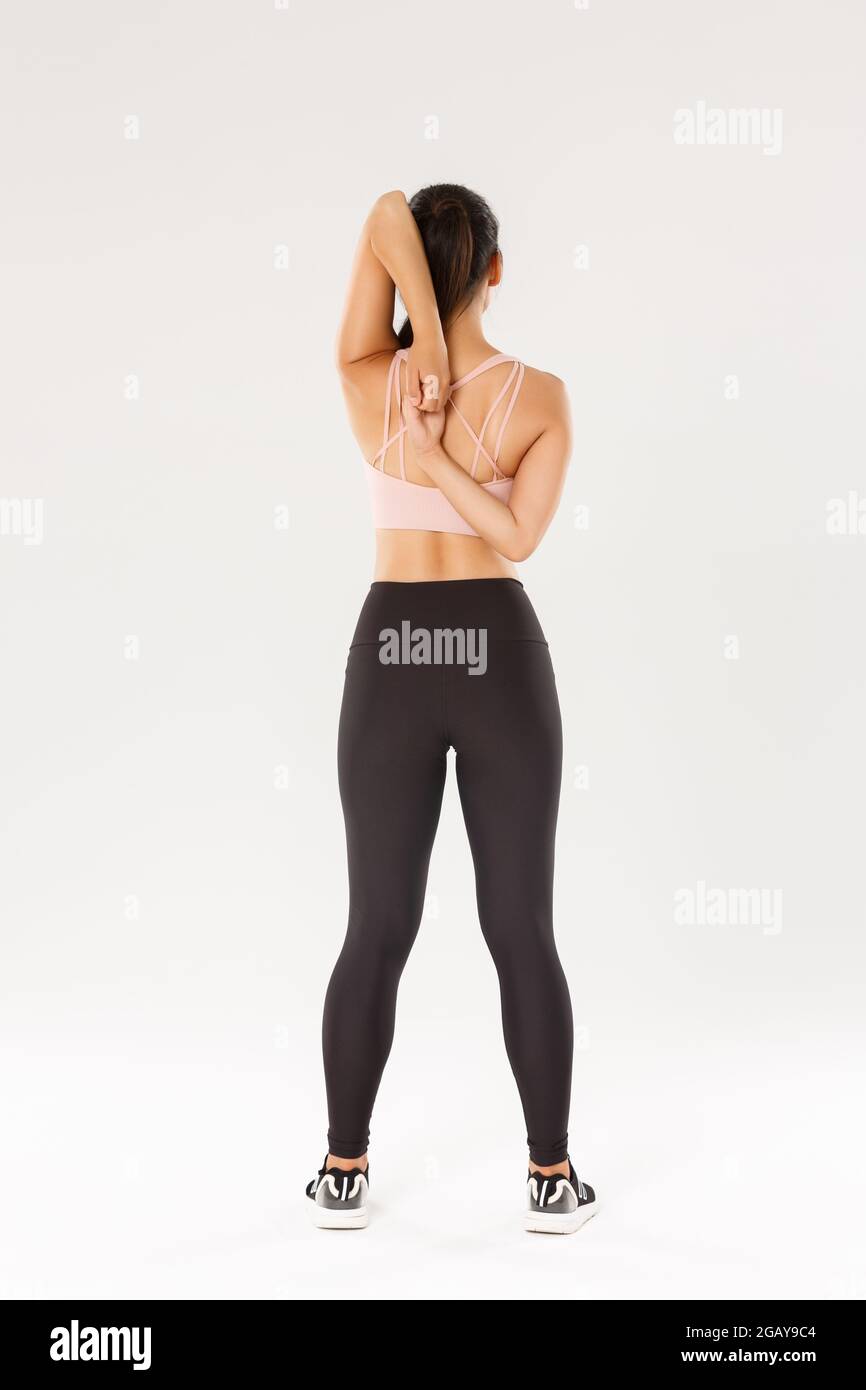 Full length rear view of active and slim asian fitness girl