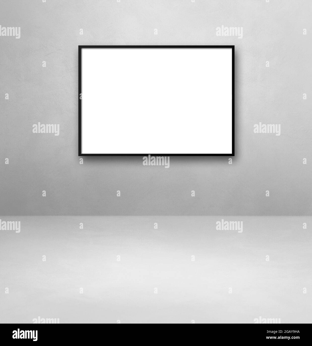 Black picture frame hanging on a light grey wall. Blank mockup template