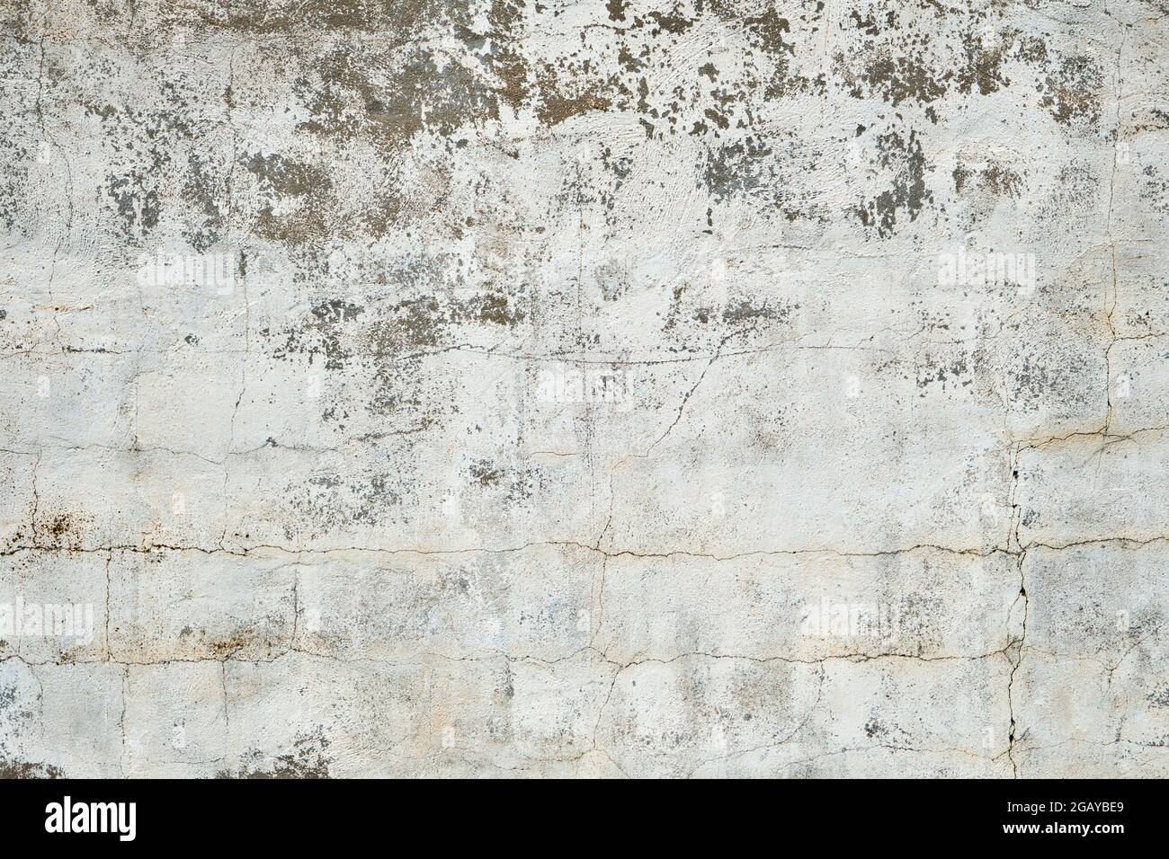 Old white cement wall with worn out plaster Stock Photo