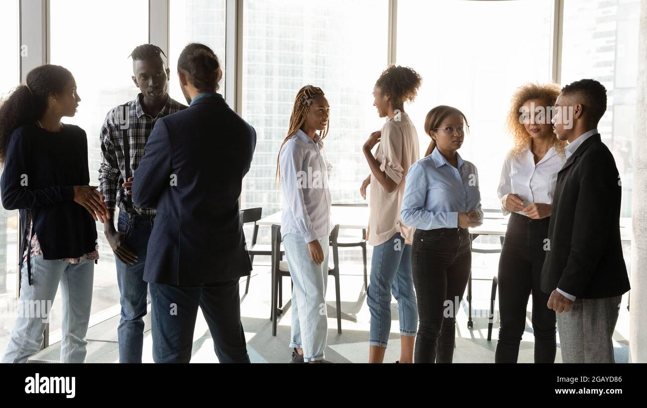 Young african american business people talking in small groups. Stock Photo