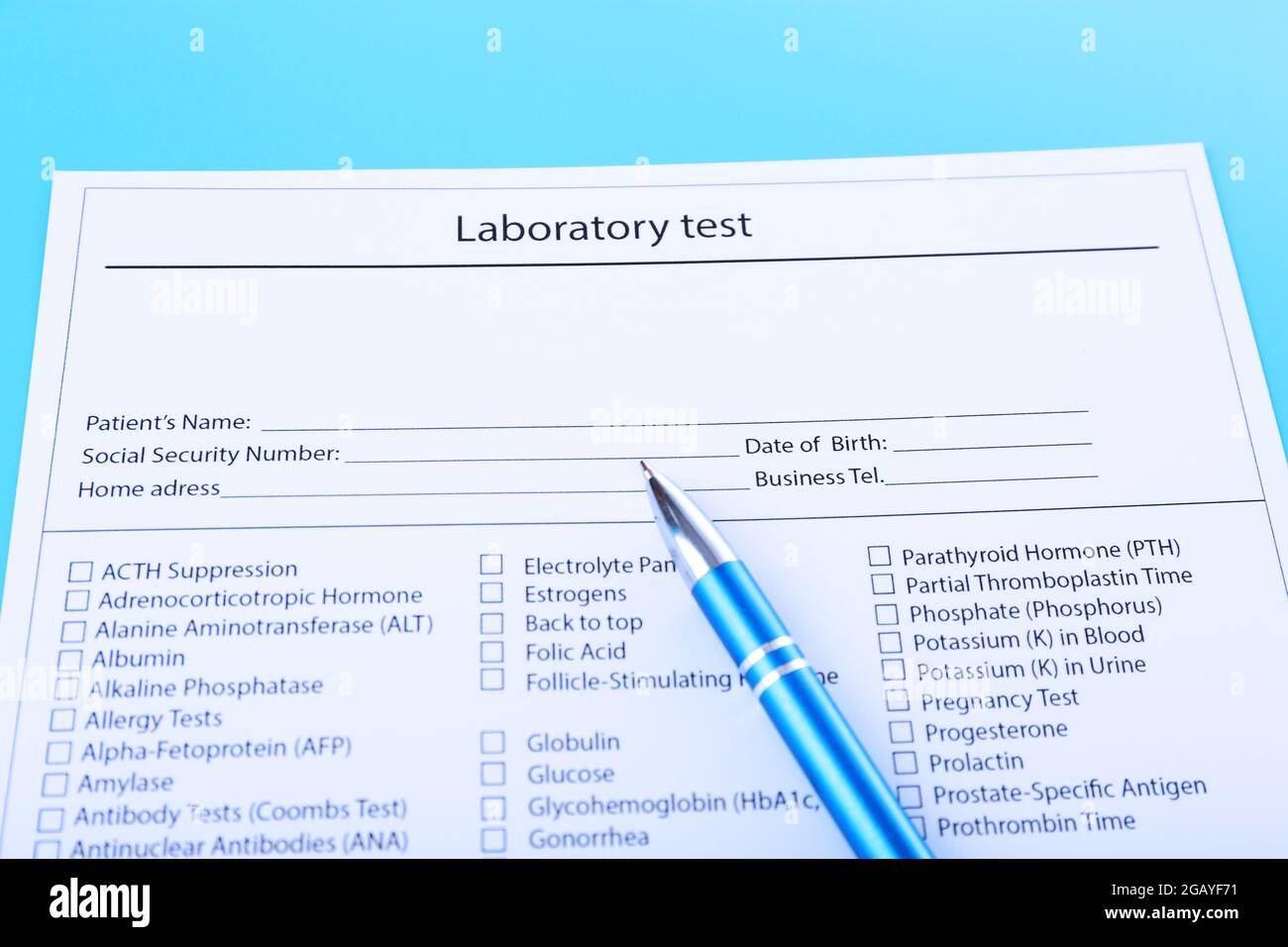 Laboratory test list with pen on blue background, close up Stock Photo